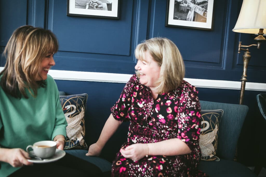 Casual meeting between Jeanette and her client Julie over a cup of tea